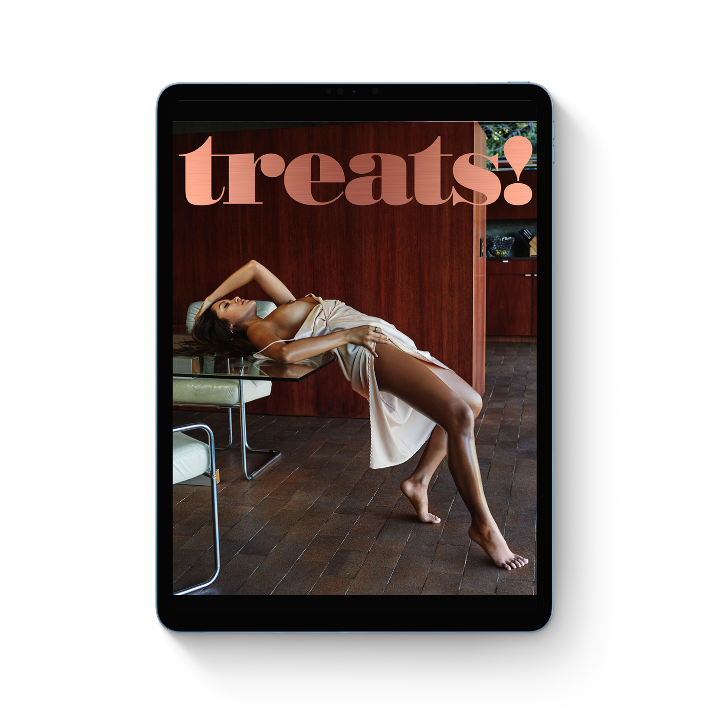 Tablet displaying a magazine cover with a woman lying on a chair and 'treats!' text.