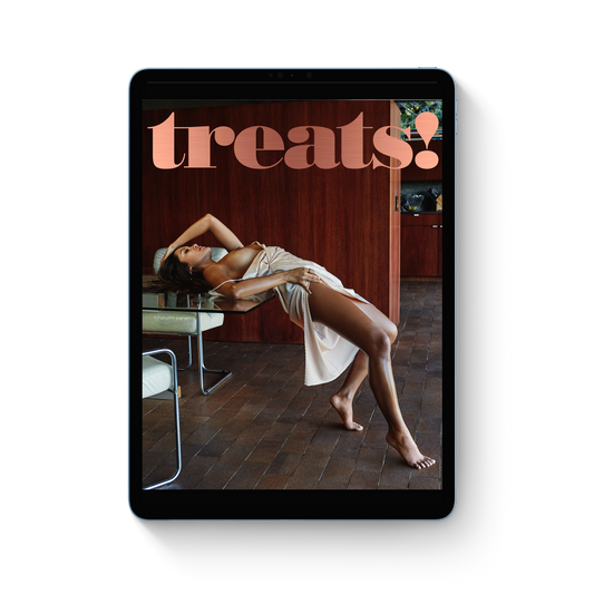 Tablet displaying a magazine cover with a woman lying on a chair and 'treats!' text.