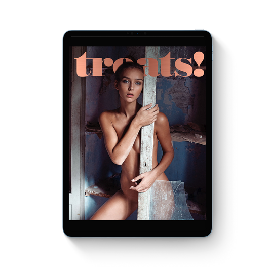 Magazine cover with a woman holding a mirror, featuring the brand 'treats!'.